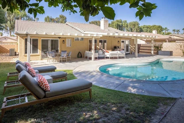 back of house with central AC unit, french doors, a fenced in pool, a patio, and an outdoor living space