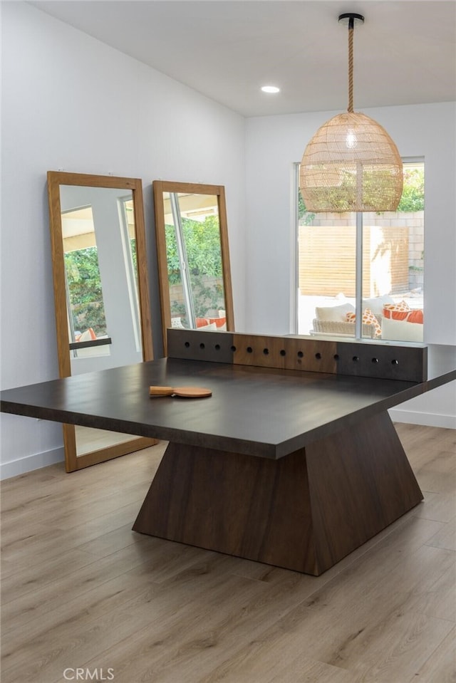 unfurnished dining area featuring light wood-type flooring