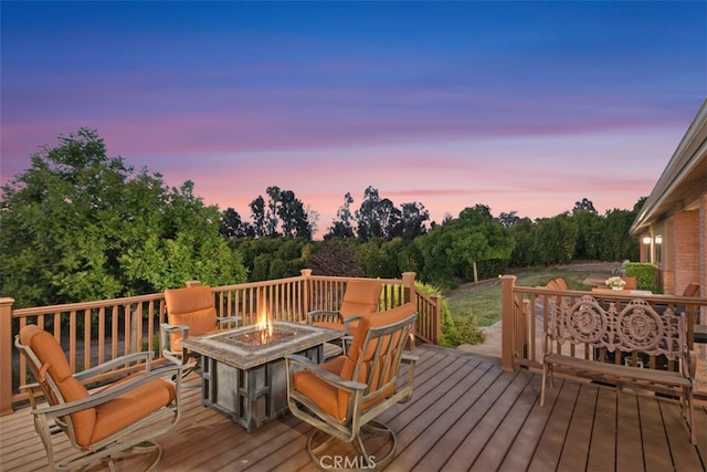 deck at dusk with a fire pit