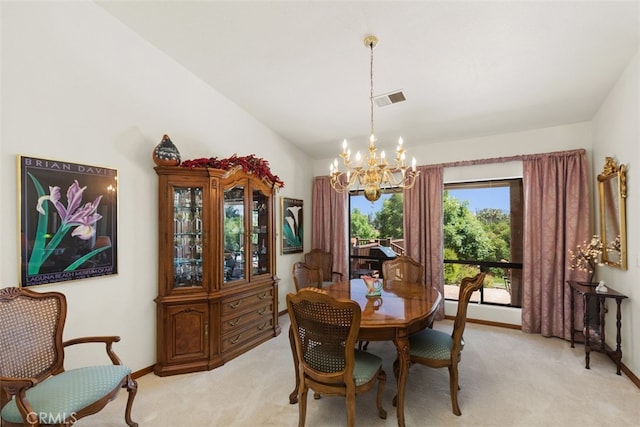 dining area with a chandelier and light colored carpet