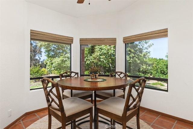 dining space with ceiling fan and light tile patterned floors