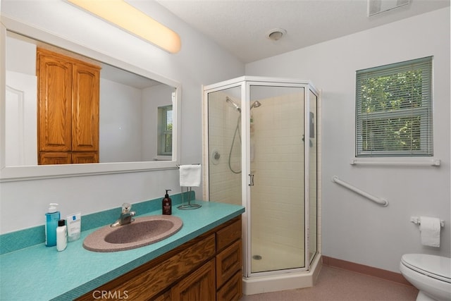 bathroom with toilet, walk in shower, and vanity