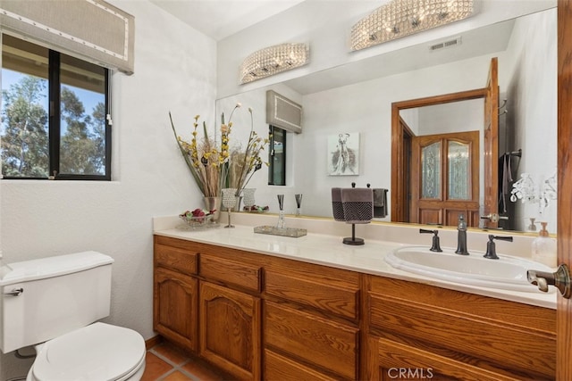 bathroom featuring vanity, toilet, and tile patterned flooring