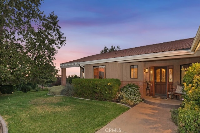 view of front of property with a yard