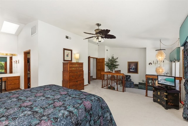 carpeted bedroom featuring a skylight and ceiling fan