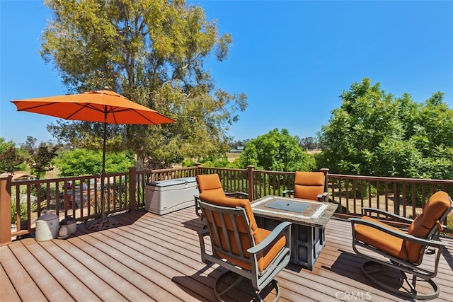 wooden deck with an outdoor fire pit