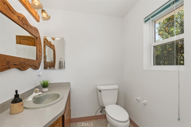 bathroom with vanity, toilet, and tile patterned floors