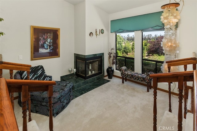 living room featuring carpet and a fireplace