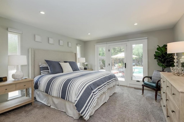 bedroom with carpet flooring, access to outside, and multiple windows