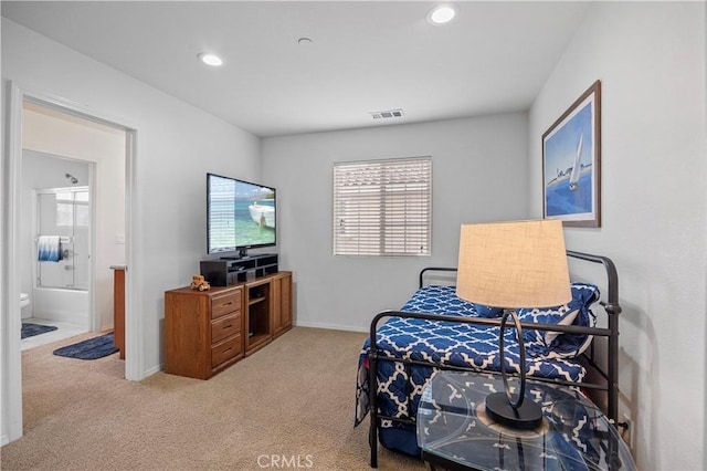 carpeted bedroom with ensuite bath, visible vents, baseboards, and recessed lighting