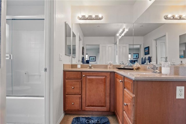 bathroom with double vanity, baseboards, and a sink