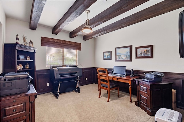 carpeted office featuring beam ceiling and wooden walls