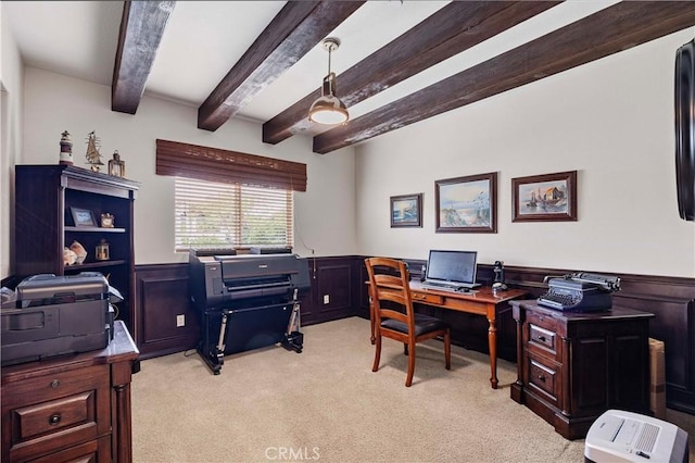 home office featuring wainscoting, light carpet, and beam ceiling