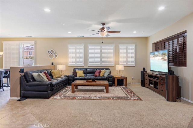 tiled living room with ceiling fan