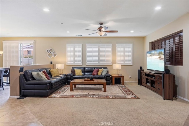 living room featuring baseboards, a ceiling fan, visible vents, and recessed lighting