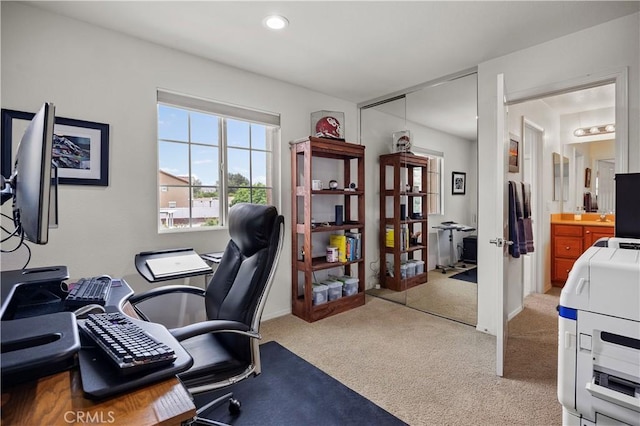 office featuring baseboards and light colored carpet
