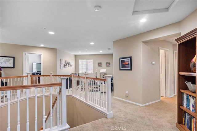 hallway featuring light colored carpet