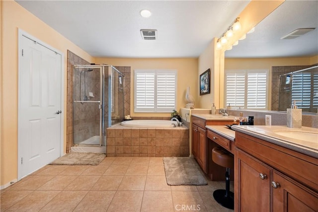 full bath featuring a bath, tile patterned floors, vanity, and a stall shower
