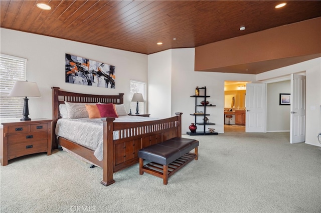 bedroom with light carpet, wooden ceiling, and ensuite bathroom