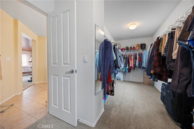 walk in closet with carpet