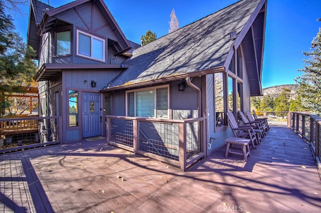 exterior space with a deck with mountain view