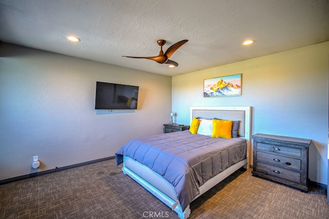 carpeted bedroom featuring a textured ceiling and ceiling fan