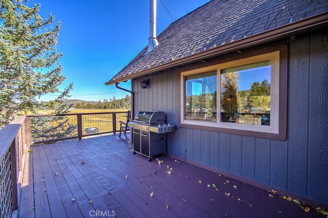 wooden deck featuring a grill