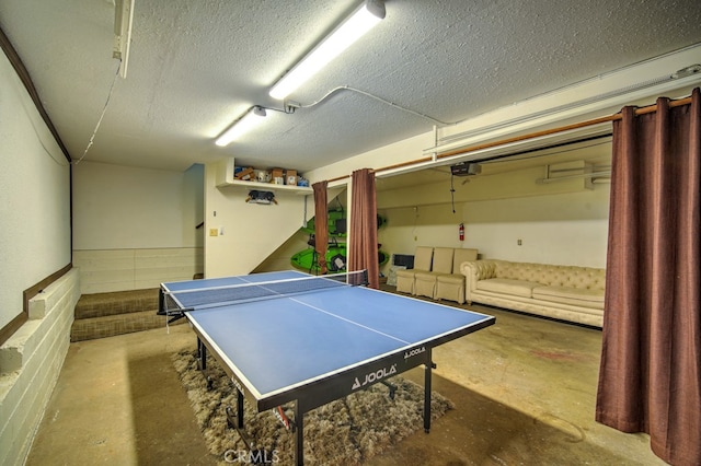 rec room featuring concrete floors and a textured ceiling