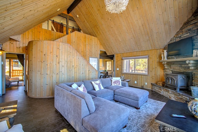 living room featuring beamed ceiling, a wood stove, and high vaulted ceiling