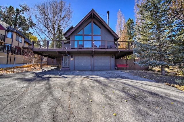 exterior space with a wooden deck and a garage