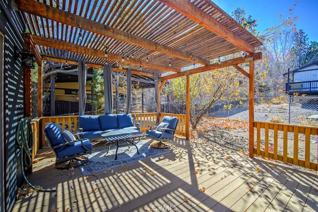 wooden terrace featuring a pergola and an outdoor living space