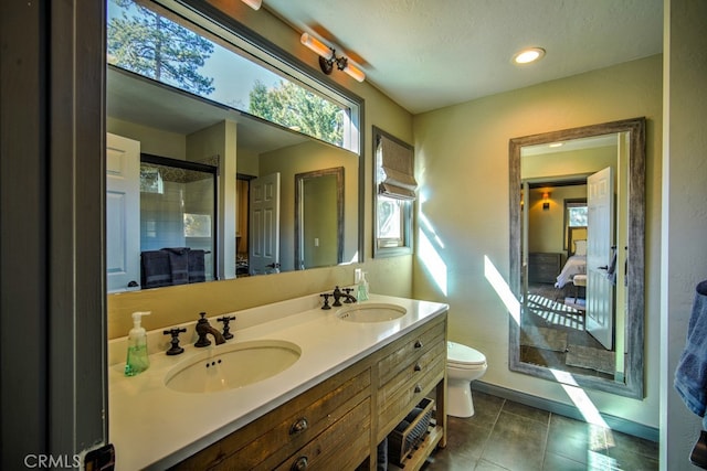 bathroom with vanity, a textured ceiling, tile patterned floors, walk in shower, and toilet