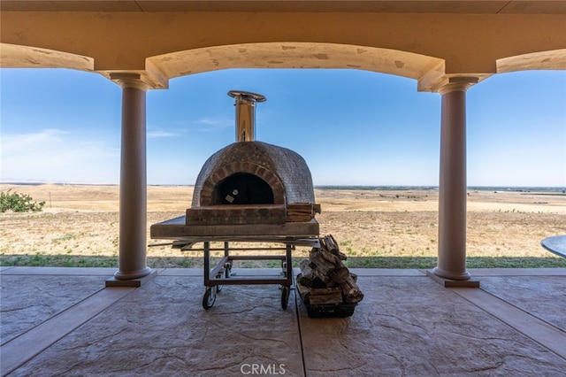 view of community with a patio and a rural view