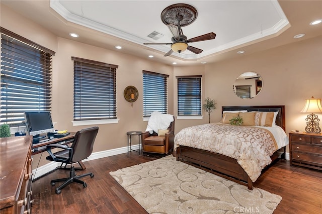 bedroom with a raised ceiling, dark hardwood / wood-style floors, and ceiling fan