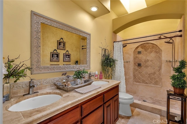 bathroom with tile patterned floors, a shower with curtain, vanity, and toilet