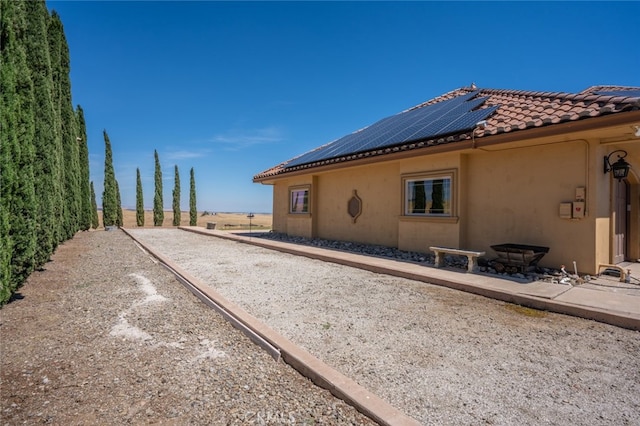 view of property exterior with solar panels