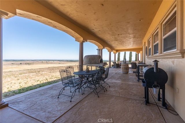 view of patio / terrace with a rural view and a grill