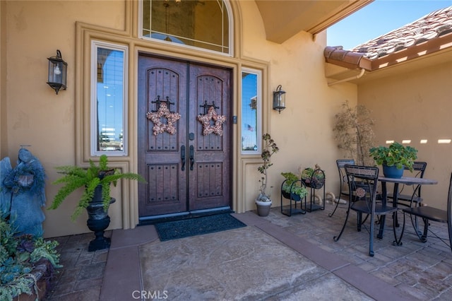 entrance to property featuring a patio