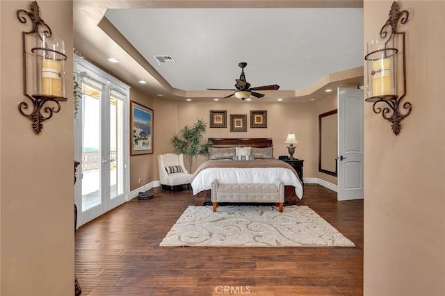 bedroom with access to outside, dark hardwood / wood-style floors, french doors, and ceiling fan