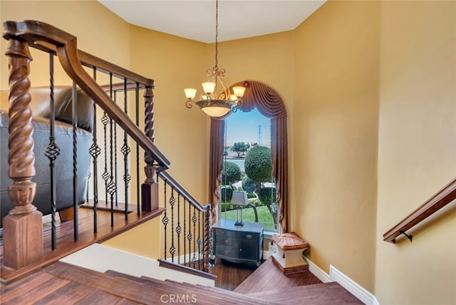 foyer with wood-type flooring, an inviting chandelier, and plenty of natural light