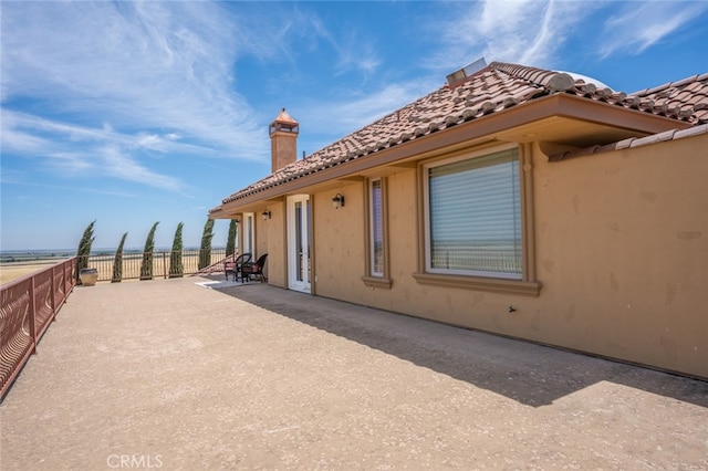 view of side of property featuring a patio area