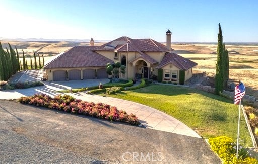 view of front facade featuring a front yard and a garage