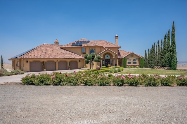 mediterranean / spanish-style home with a garage