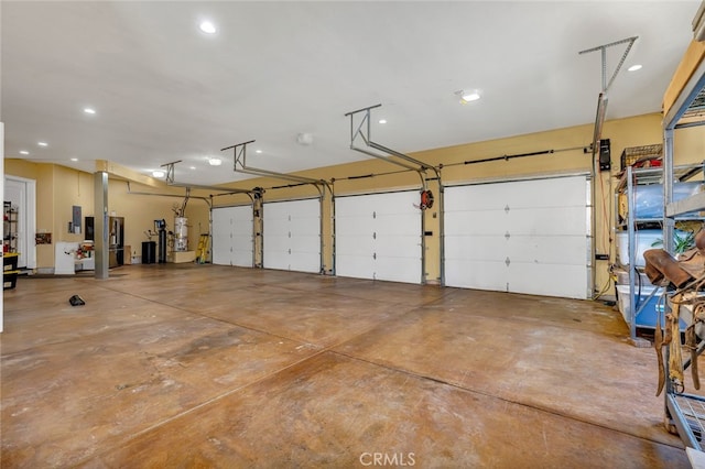 garage featuring electric panel and secured water heater