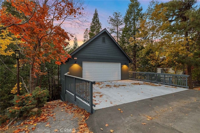 view of garage at dusk