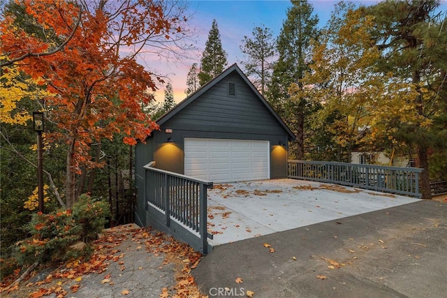 view of garage at dusk