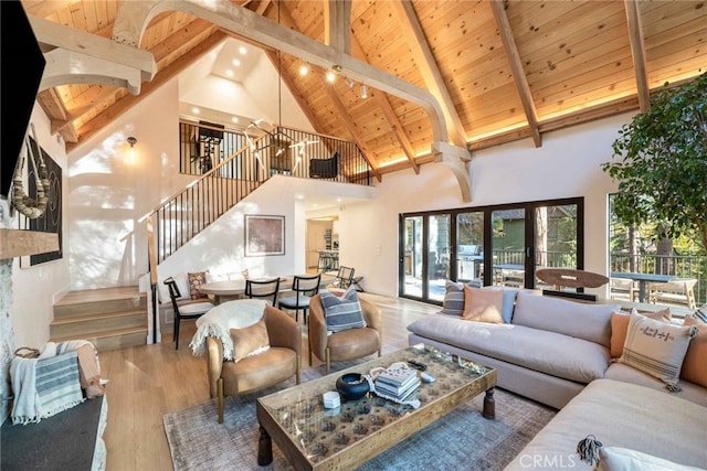 living room with hardwood / wood-style floors, high vaulted ceiling, wooden ceiling, french doors, and beamed ceiling