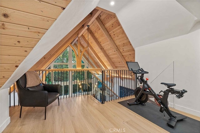 exercise area featuring lofted ceiling, wood-type flooring, and wooden ceiling