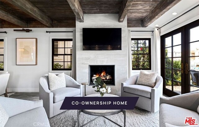 living room with beamed ceiling, french doors, and wood ceiling