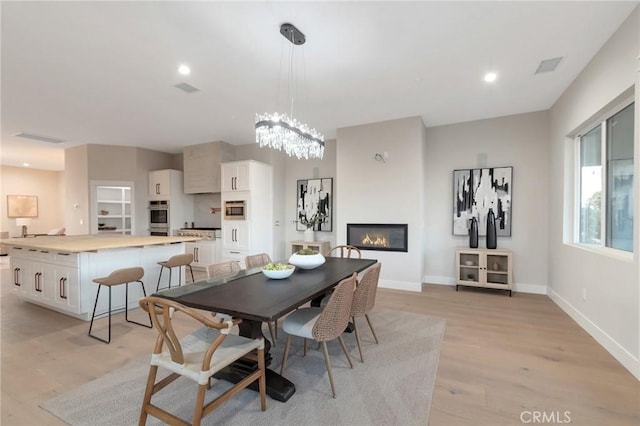 dining space with light hardwood / wood-style flooring